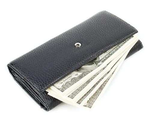 A black wallet with bills showing to demonstrate saving money with Modern event furniture rental