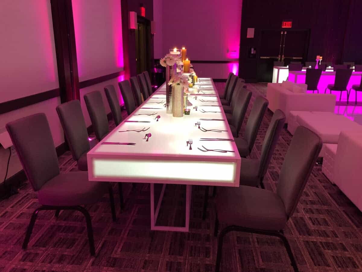 An outdoor event space filled with glowing LED furniture. Detroit Illuminated LED furniture rentals