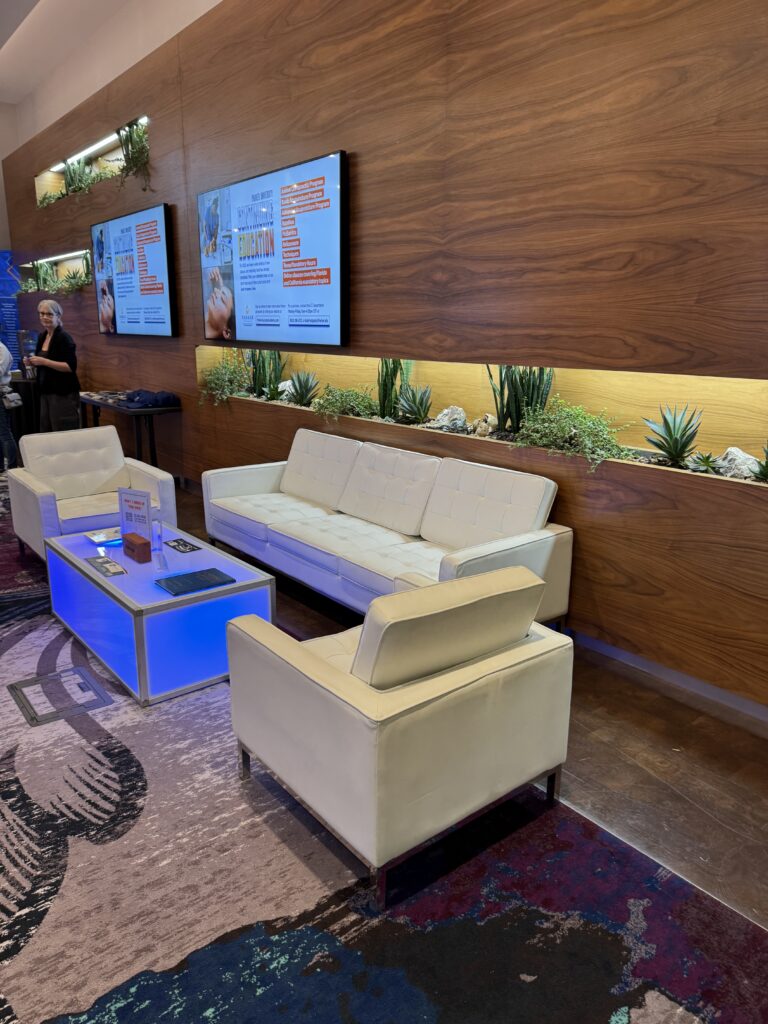 Sponsor Lounge Furniture: How to Spec a Branded Lounge That Works 1 Conference lounge furniture with cream sofas, armchairs and an illuminated coffee table in a sponsor lounge